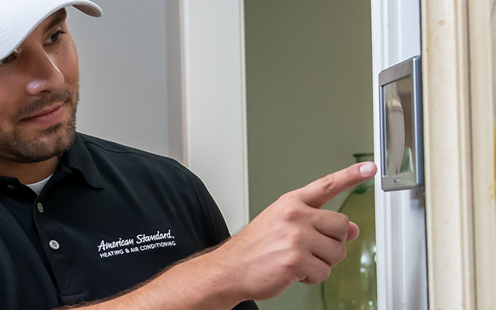 Man sets American Standard AccuLink thermostat