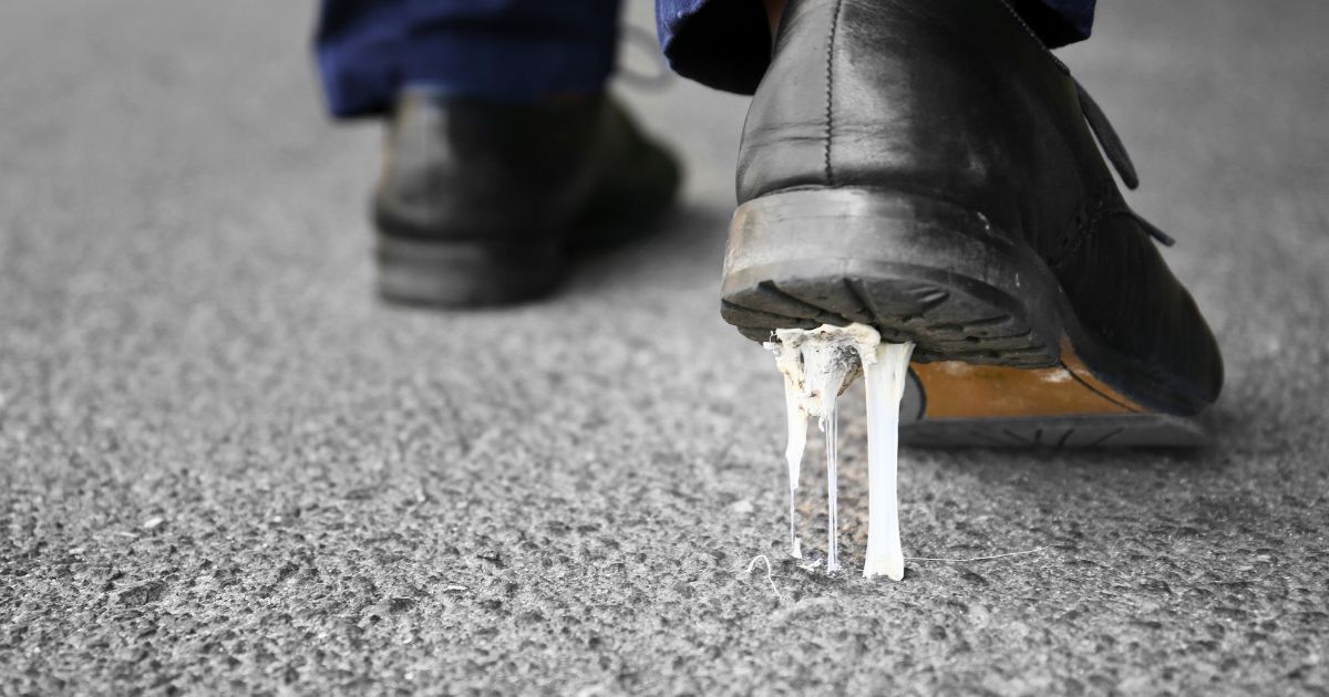 man stepping on gum