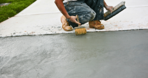 person working on a newly paved driveway