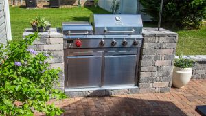 Beautiful Dyna-Glo gas grill with Pavestone grill surround