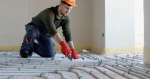 man installing floor heating