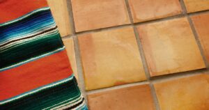 colorful carpet over saltillo tile