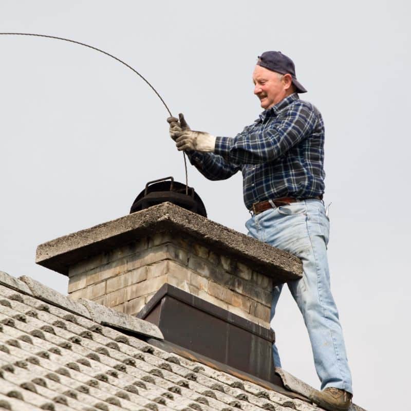 man performing a chimney cleaning and inspection